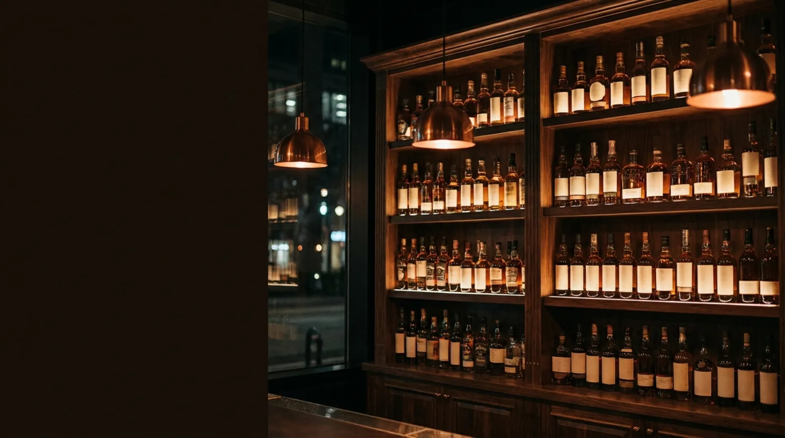 Shelves of spirits displayed behind a liquor store bar